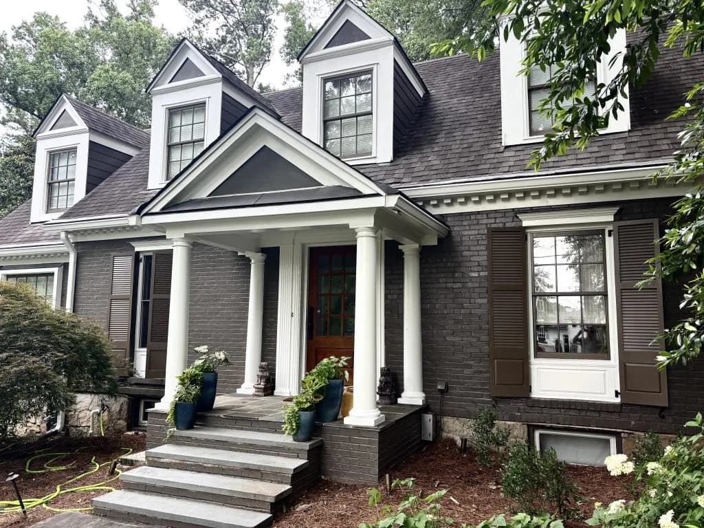 Dark brick colonial exterior with white columns painted by OVO Painting in Atlanta