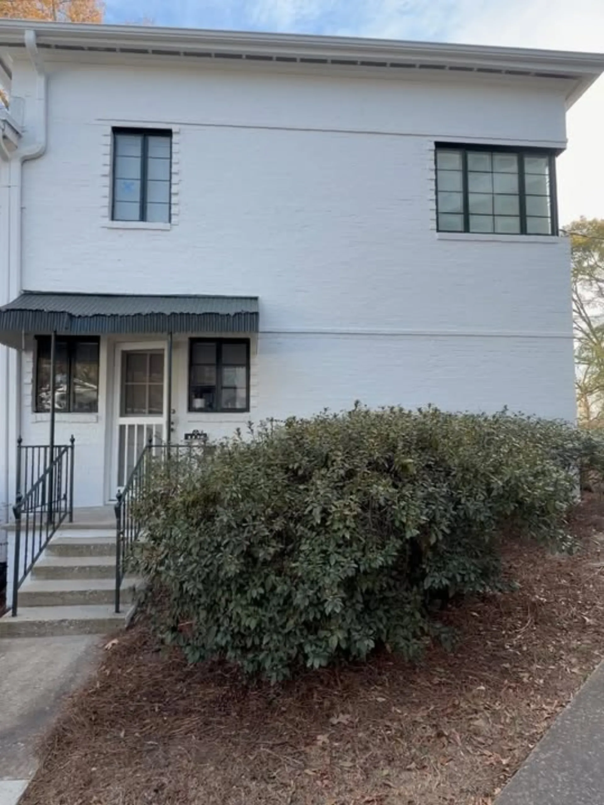 Painted brick exterior beneath horizontal siding