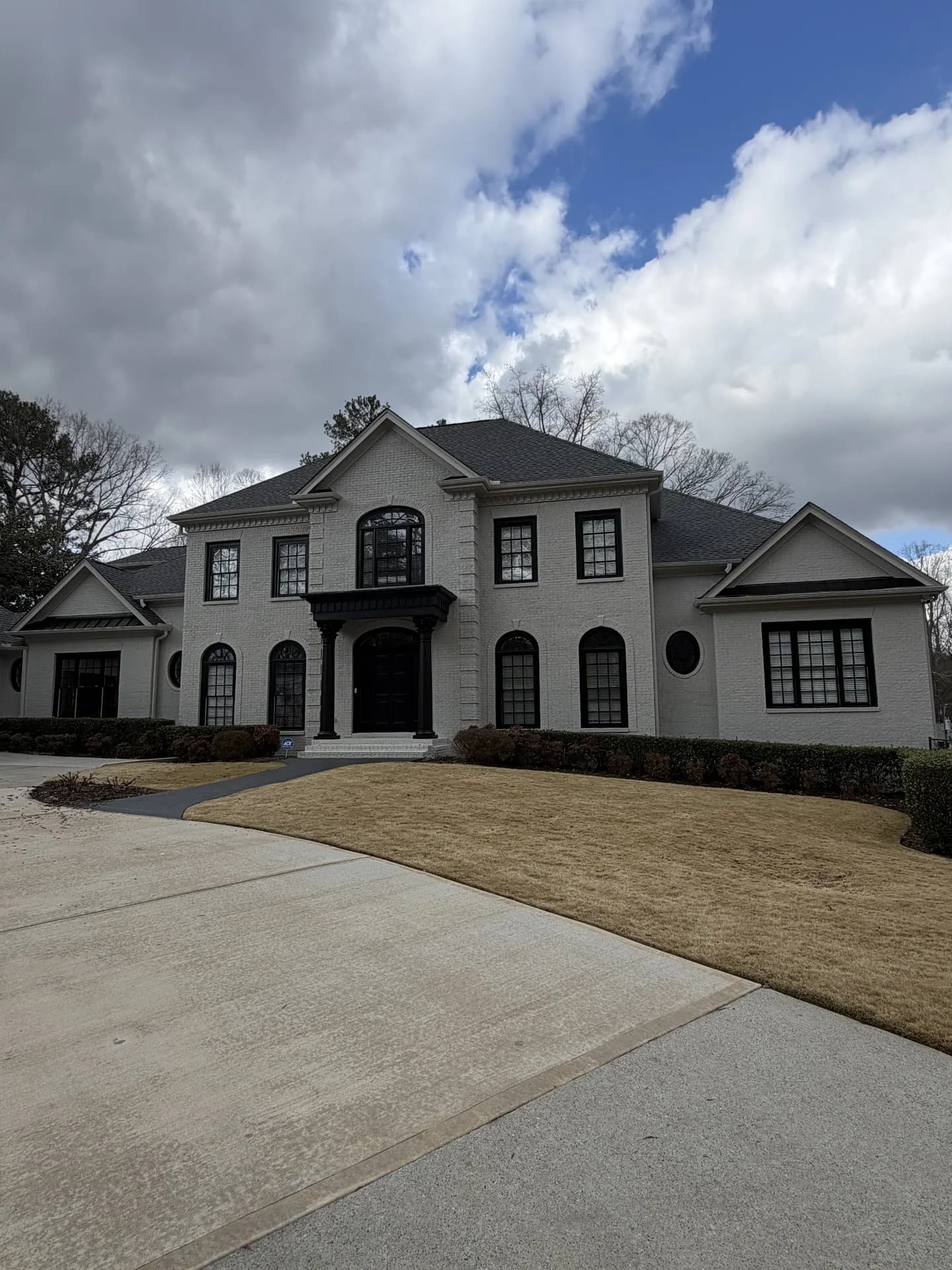 Painted two-story exterior with a columned entry