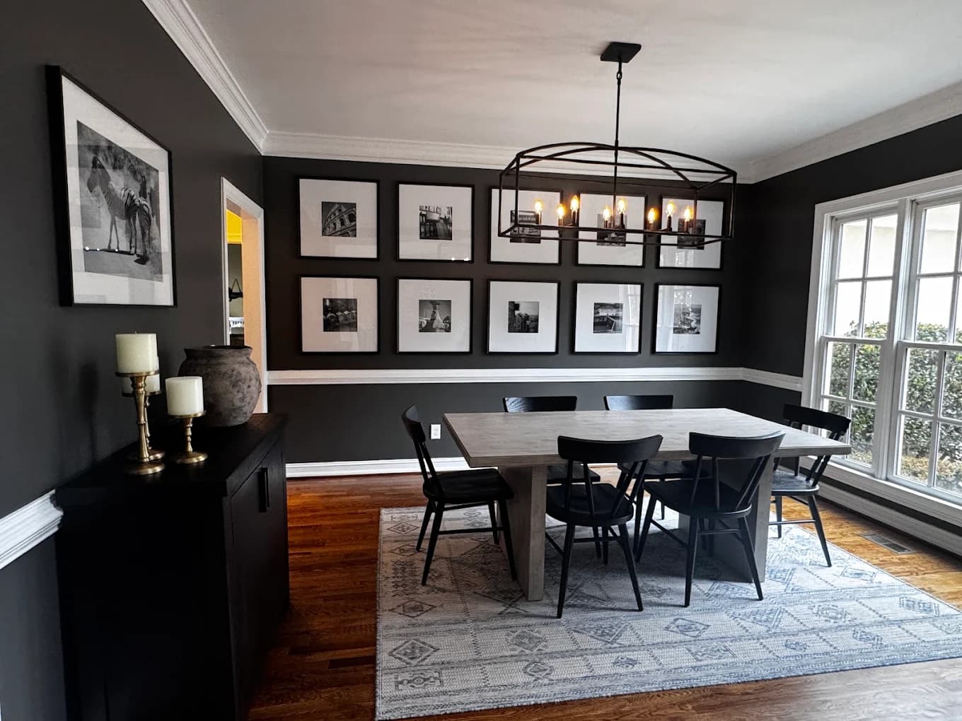 Dining room with dark painted walls and white trim