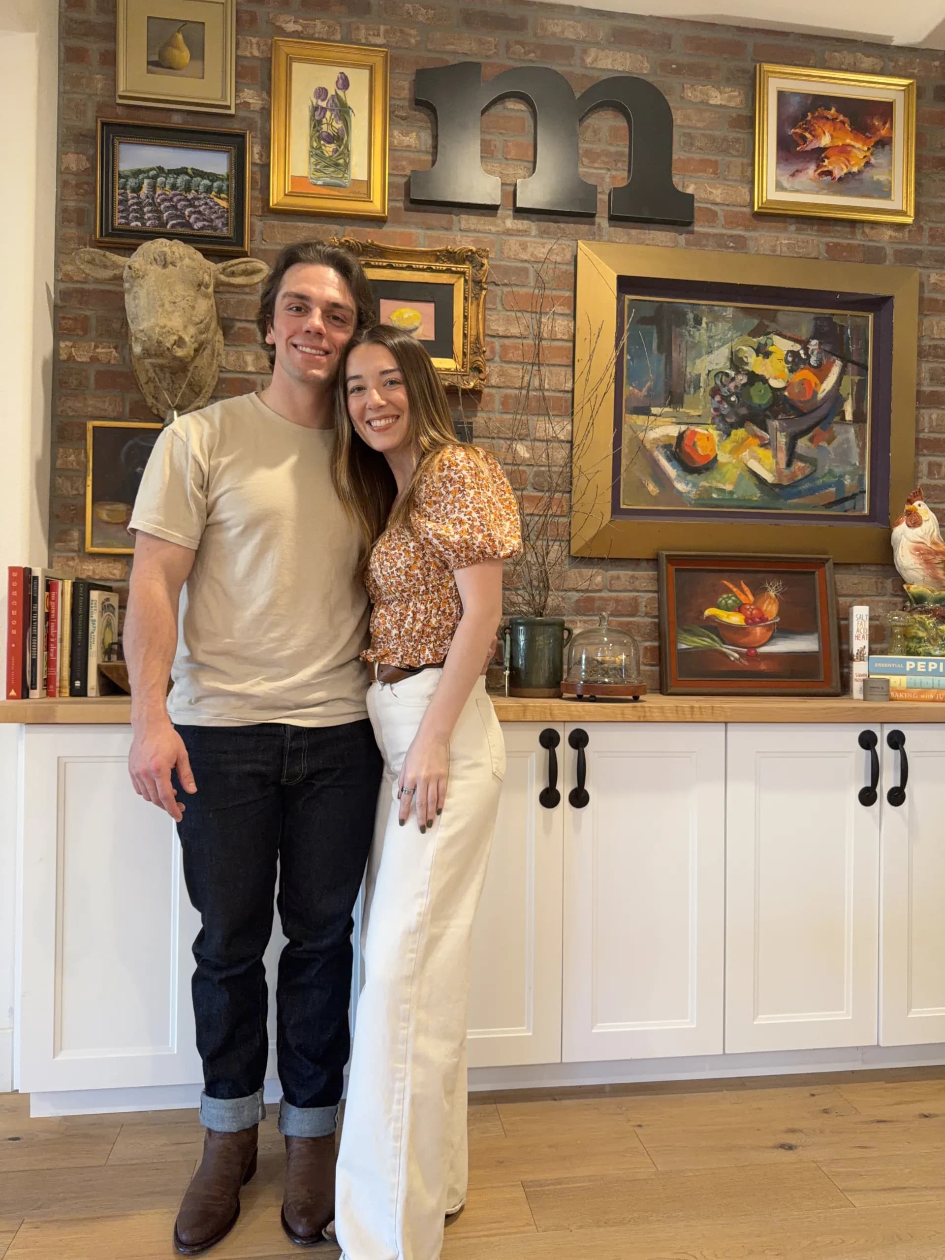 Sebastian and Madison Thomas in front of an art collection