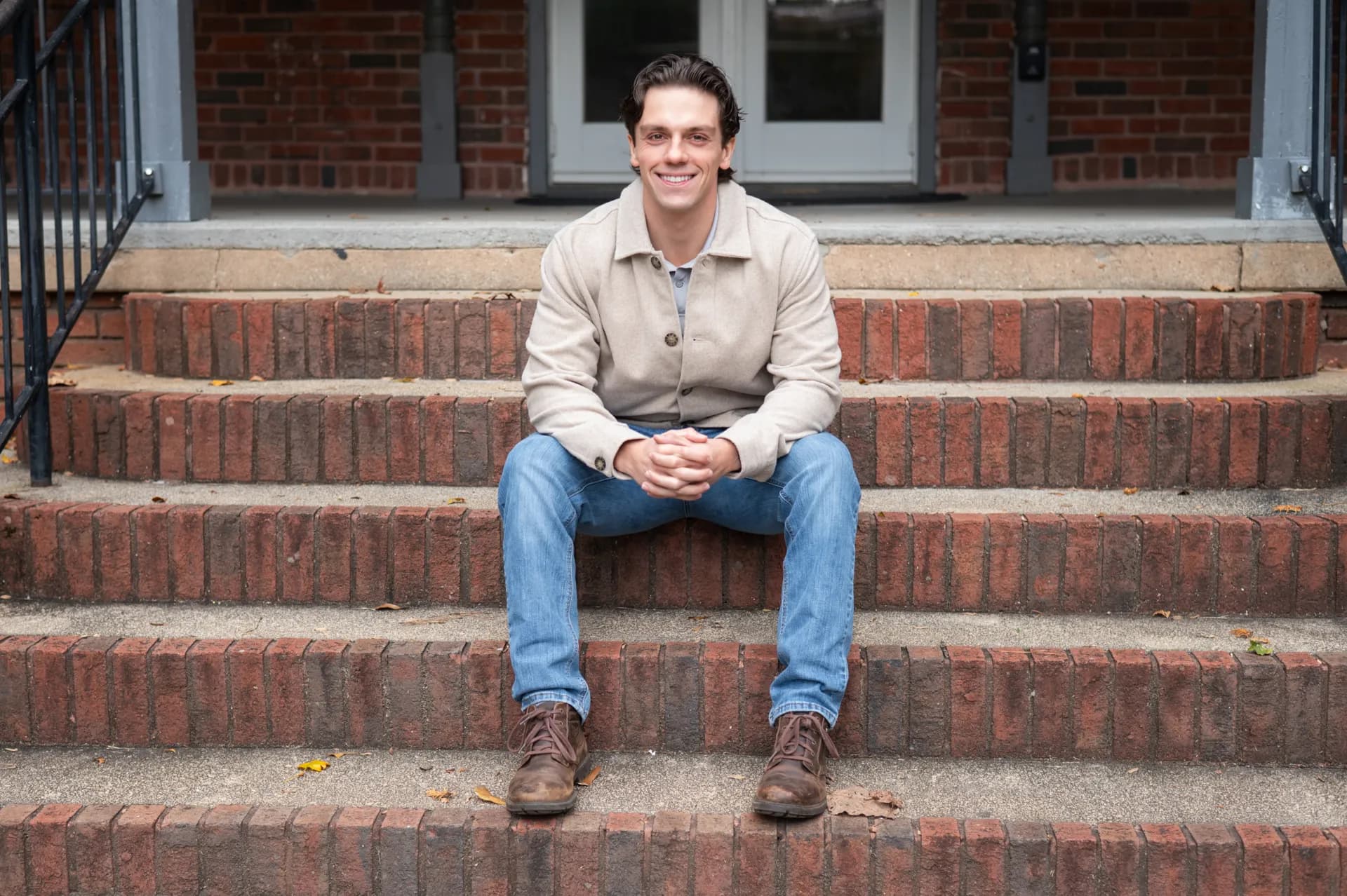 Sebastian Thomas on a residential front porch