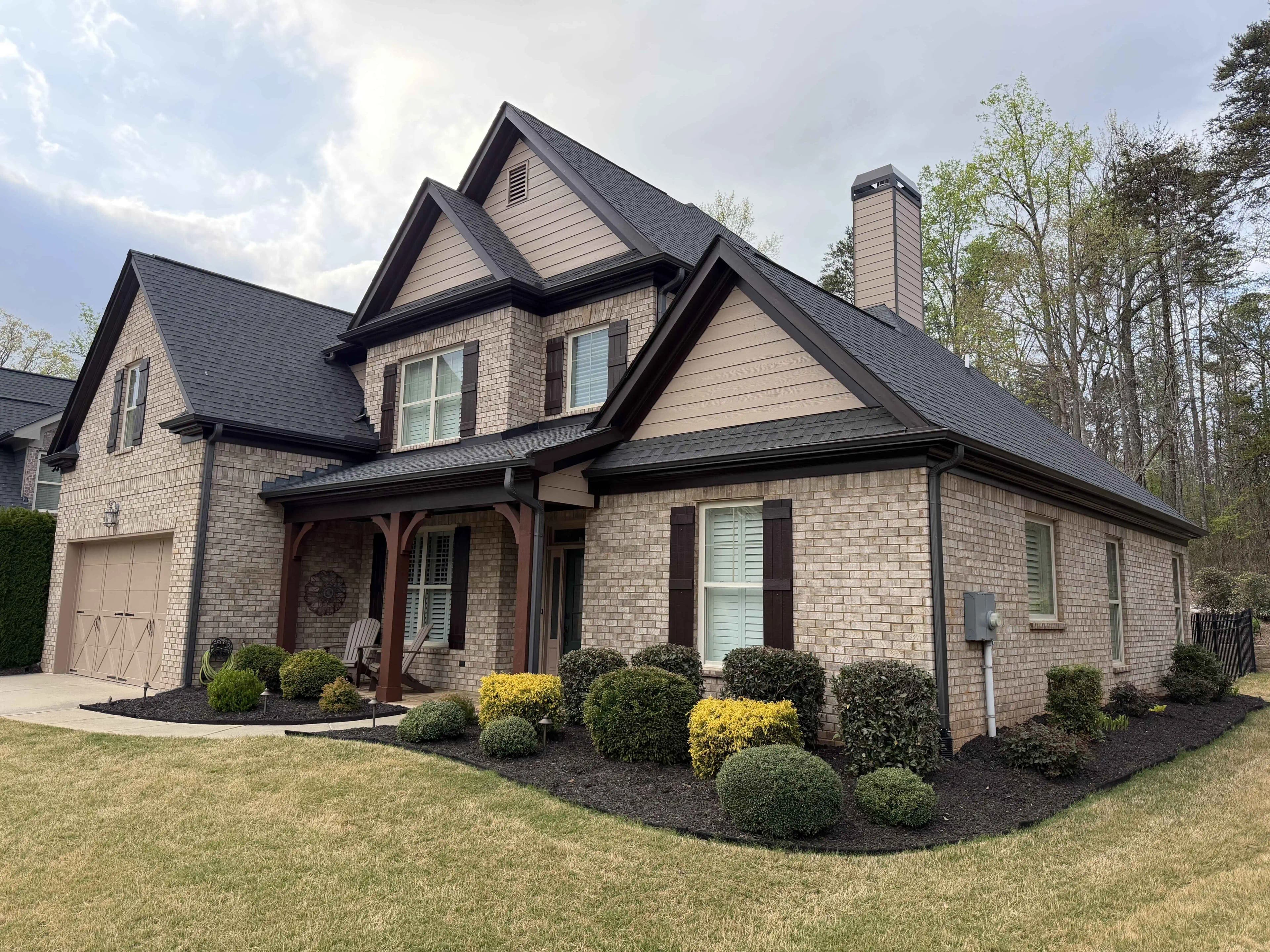 Two-story brick home before painting