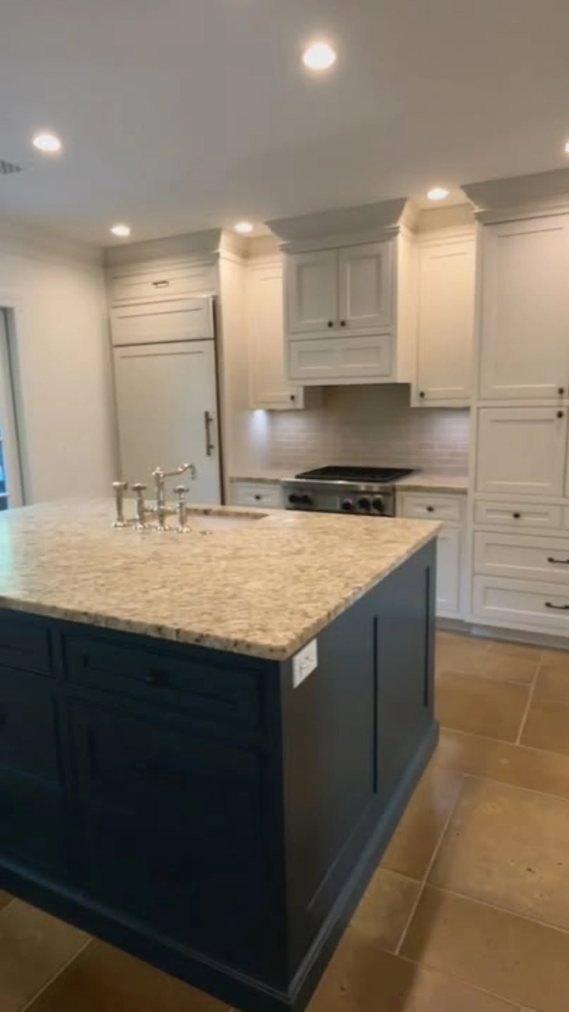 White kitchen cabinets with navy island painted by OVO